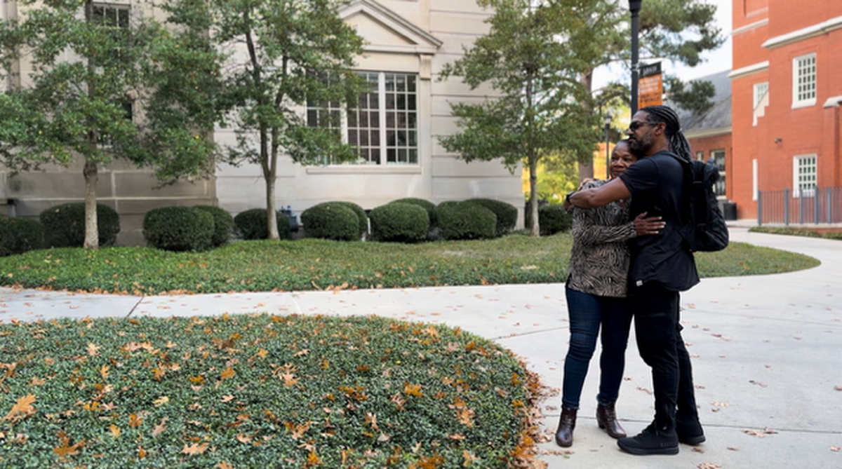 Macon native and Mercer University alumna Gwendolyn Payton hugs her son, Khary Payton, director of The Faith of the Dreamer, a film that follows her decades-long journey of healing from a heartbreaking college experience.