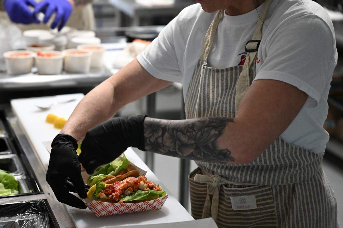 Tia Small assembles two Connecticut lobster rolls at Tia’s Maine Lobster Rolls, a new takeout restaurant in Warner Robins that she owns and operates with her husband, Chris. The lobster is shipped from the East Coast.
