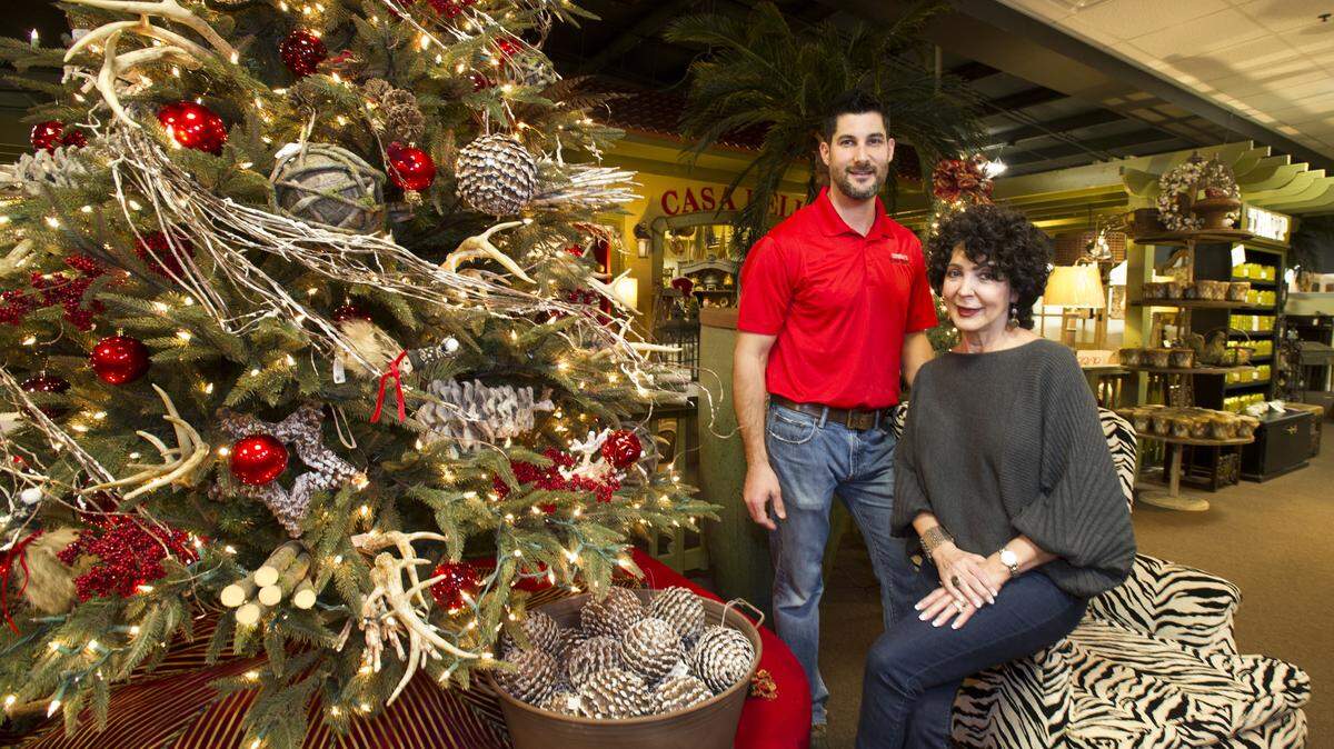 Brandon Giles and his mother, Dianne Giles, pose for a photo at their family-owned business, Yesterday's Antique Market.