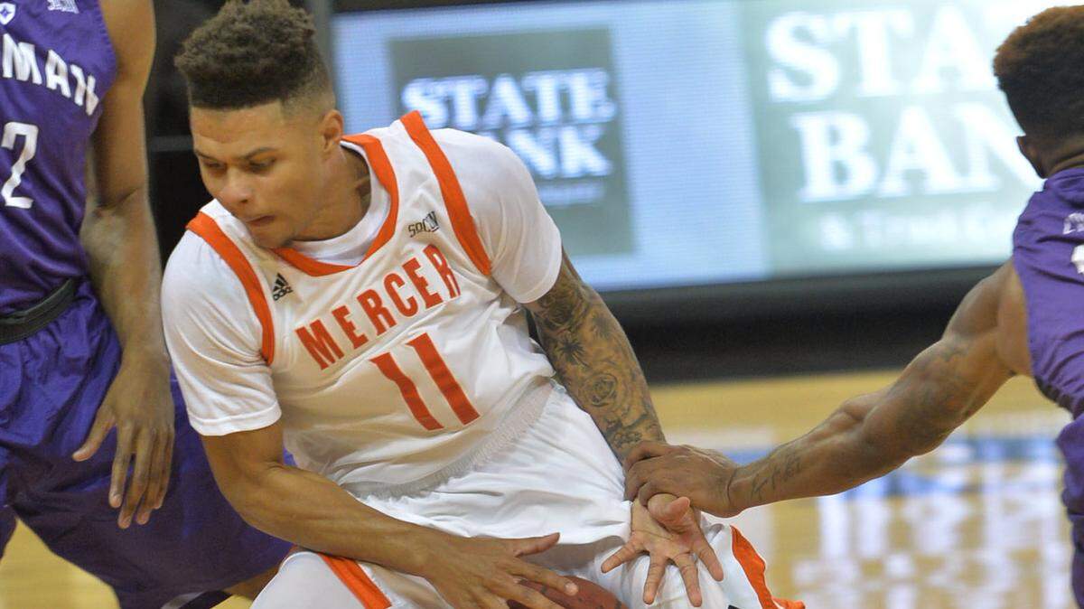 Mercer guard Jordan Strawberry (11) drives the lane against Furman during first half action.