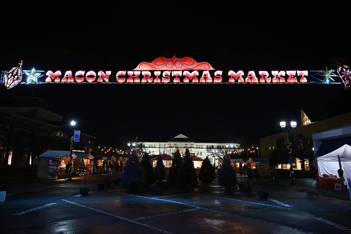 A sign advertising the Macon Christmas Market hangs above the market on Thursday, Dec. 4, 2025, along Cherry Street in downtown Macon, Georgia. The inaugural Macon Christmas Market is modeled after a traditional German Christmas market and features a number of small business vendors.