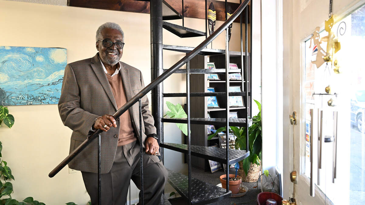 Macon-Middle Georgia Black Pages founder and publisher Alex Habersham stands on the spiral staircase leading to his office on Tuesday, Feb. 24, 2026, in Macon, Georgia. Habersham started the Black Pages in 1991, which will publish its final print edition this year before shifting to all digital.