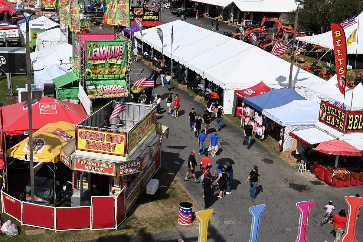 Fair attendees walk past food stalls at the Georgia National Fair on Oct. 6 in Perry, Georgia. 