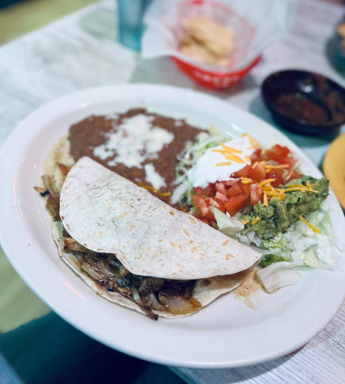 Grilled chicken quesadilla with a Mexican salad and beans at Chevo’s Mexican in Macon.