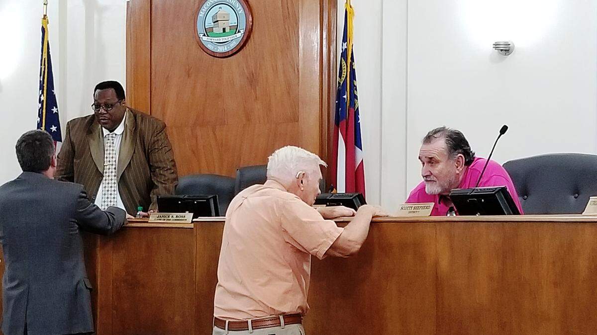 Attorney George Greer, left, speaks with Macon-Bibb County Commissioner Al Tillman, and resident Arthur Brook, center, speaks with Commissioner Joe Allen, after a public hearing Wednesday to discuss the way the Macon-Bibb County Planning & Zoning Commission operates.