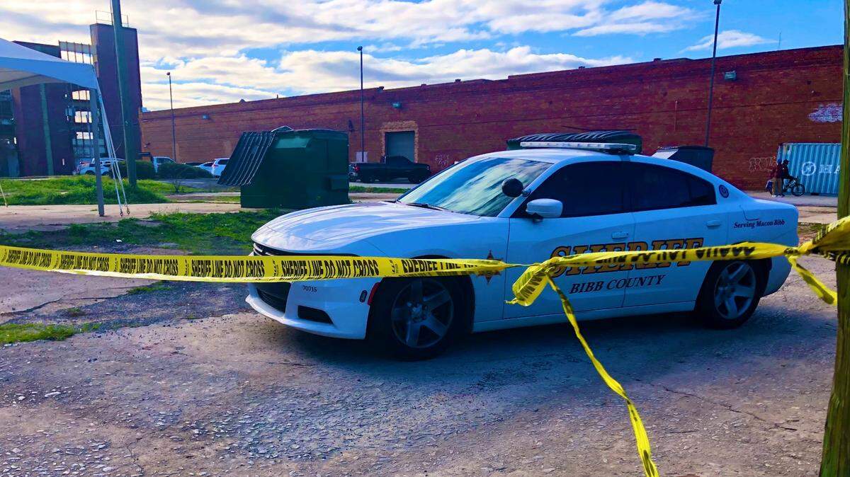 A Bibb County sheriff’s patrol car parked along an alley beside the Loaves & Fishes Ministry at 651 Martin Luther King Jr. Blvd. in downtown Macon on Tuesday in the wake of a fatal shooting there.