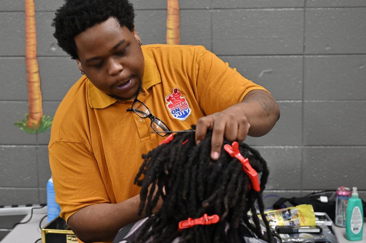 Barber Jordan Poe cuts a student’s hair on Monday, May 19, 2025, at Union Elementary School in Macon, Georgia. Poe has worked as a barber for two years and volunteered his time with Barbers on Duty for two months.