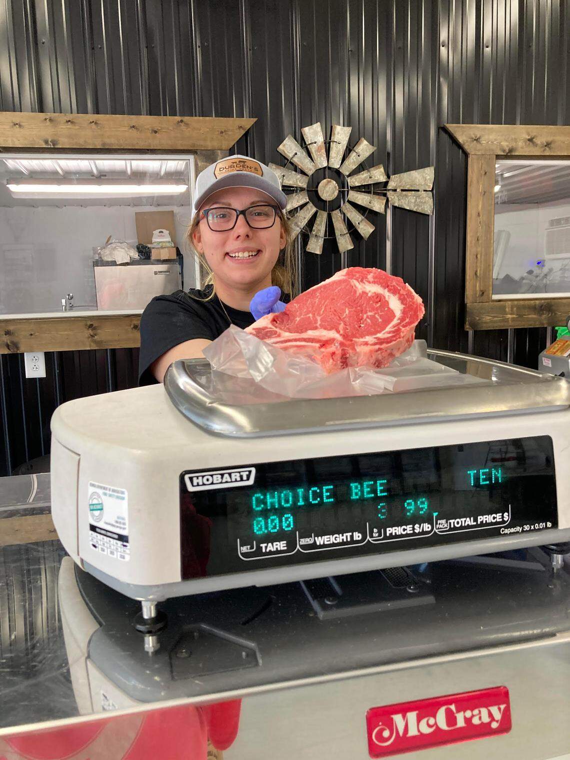 Amber Clark weighs a steak at Durden’s Prime Meats in downtown Perry.
