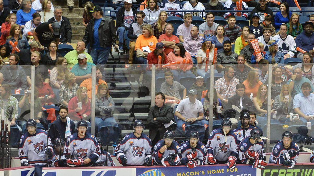 Mayhem coach Kevin Kerr (center) stands with his team as he watches first period action in their season opener against Knoxville in October at the Macon Coliseum.