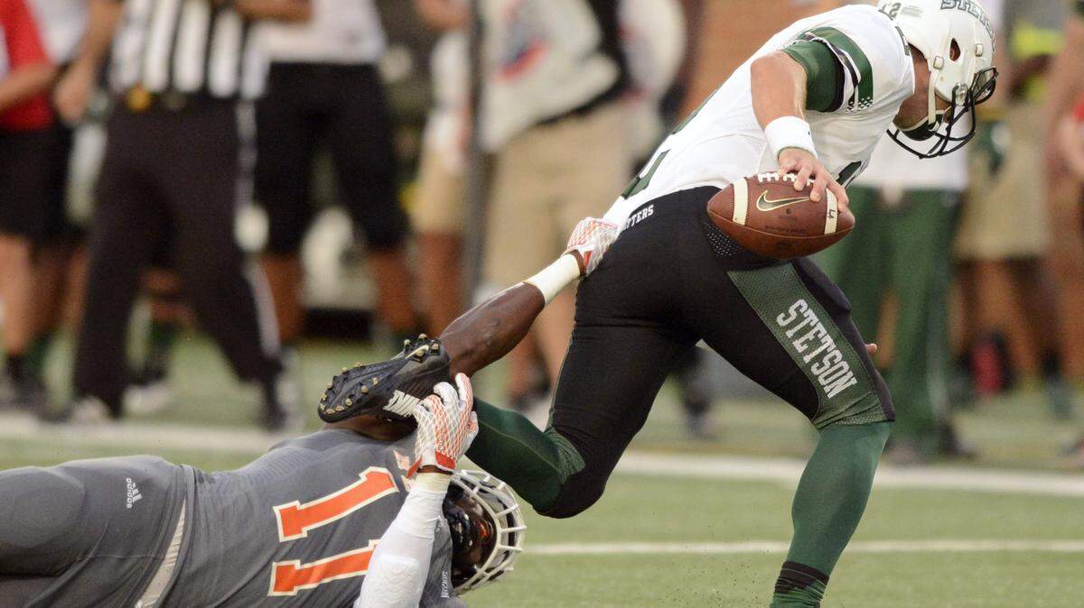 JASON VORHEES/THE TELEGRAPH Macon, GA, 09/12/2015: 
 Mercer linebacker Tosin Aguebor (11) sacks Stetson quarterback Blake Plattsmier (12) during their game Saturday.