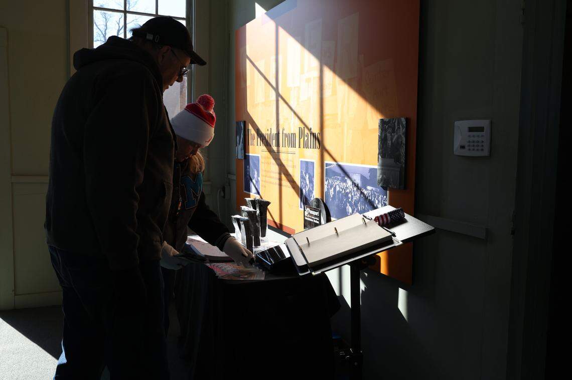 Visitors look at information on former president Jimmy Carter inside of his old campaign headquarters, which has been converted into a museum, on the day of former president Carter’s funeral in his hometown of Plains on Thursday, Jan. 9, 2025, in Plains, Georgia. A funeral service for Carter was held in Washington D.C. on Thursday morning with an additional funeral service later in the afternoon in Plains, where he will then be buried next to his wife Rosalynn Carter on his family’s peanut farm.