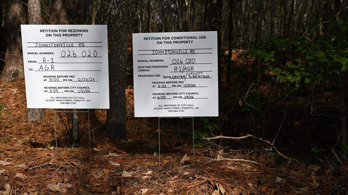 Signs advertising City of Forest Planning and Zoning committee meeting sits on the side of Johstonville Road on Tuesday, Dec. 9, 2025, in Forsyth, Georgia. The Forsyth Technology Campus is proposed for land around Johnstonville Road, which would consist of up to 12 million square feet of technology facility buildings.