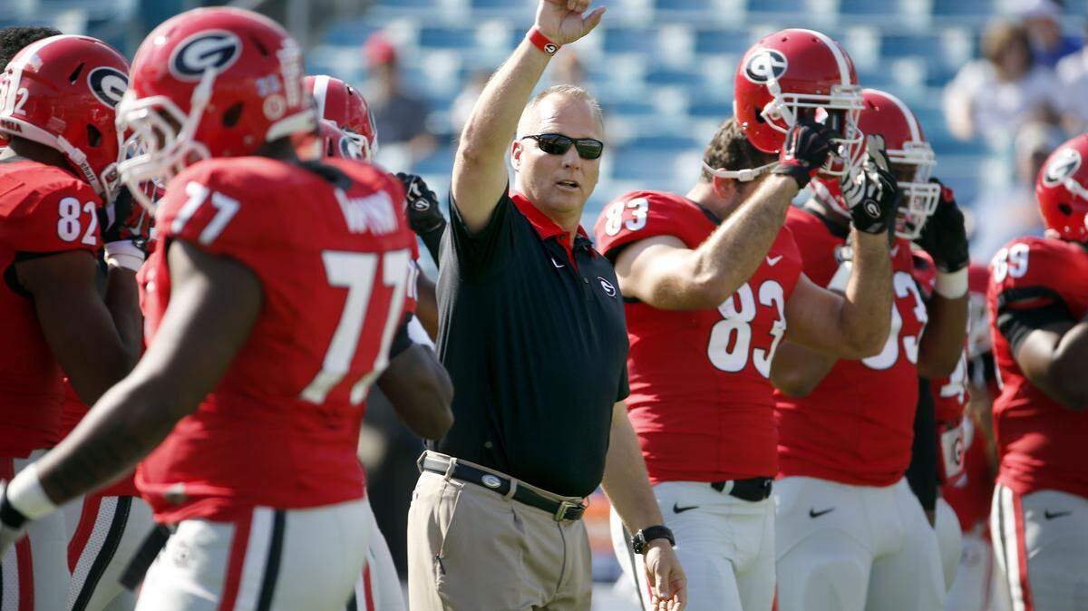 Georgia head coach Mark Richt takes the field with his team during warms up before the start of an NCAA college football game against Florida Saturday, Oct. 31, 2015, in Jacksonville, Fla. (AP Photo/Stephen B. Morton)