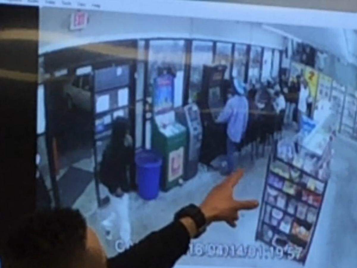 This still from security camera footage at Jaffary’s Food Mart on Anthony Road in April shows an alleged armed robber entering the store. Marlon Williams, who was later shot outside the store on Mason Street, can be seen in blue. Bibb County sheriff’s investigator Marcus Baker is pointing to Williams in the picture.