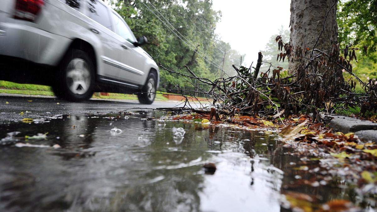 WOODY MARSHALL/THE TELEGRAPH 
 A vehicle travels along Vista Circle, past a small pile of tree limbs placed in the gutter. Some Macon-Bibb County leaders say a new garbage and recycling agreement that kicks off in 2016 will lead to yard waste being collected more frequently.