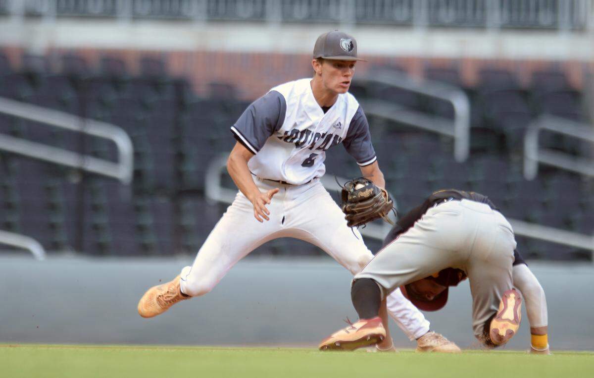 Houston County shortstop Trent Ringer (6) tags out LassiterÕs Parker Hughes (13) in a run down during game one of the BearsÕ GHSA 6A Championship series against Lassiter Wednesday in Atlanta.