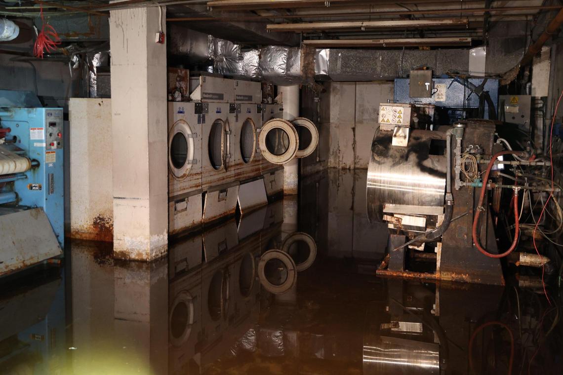 The laundry room of the abandoned Ramada Hotel sits flooded on Thursday, Dec. 12, 2024, in downtown Macon, Georgia. Contractors working on the property said that some areas of the building have 8-10 inches of water, especially in the basement where the laundry room is located.