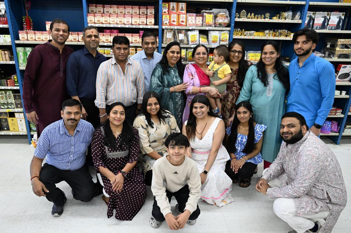 Members of the five families (minus Jay Patel who is not pictured) who co-own the new Maharaja Market in Warner Robins pose for a picture on Wednesday, April 16, 2025, at its grand opening. The families all attend the same Hindu temple and opened the Indian-Pakistani grocery store as a place to offer fresh produce and specialty goods that are hard to find locally.