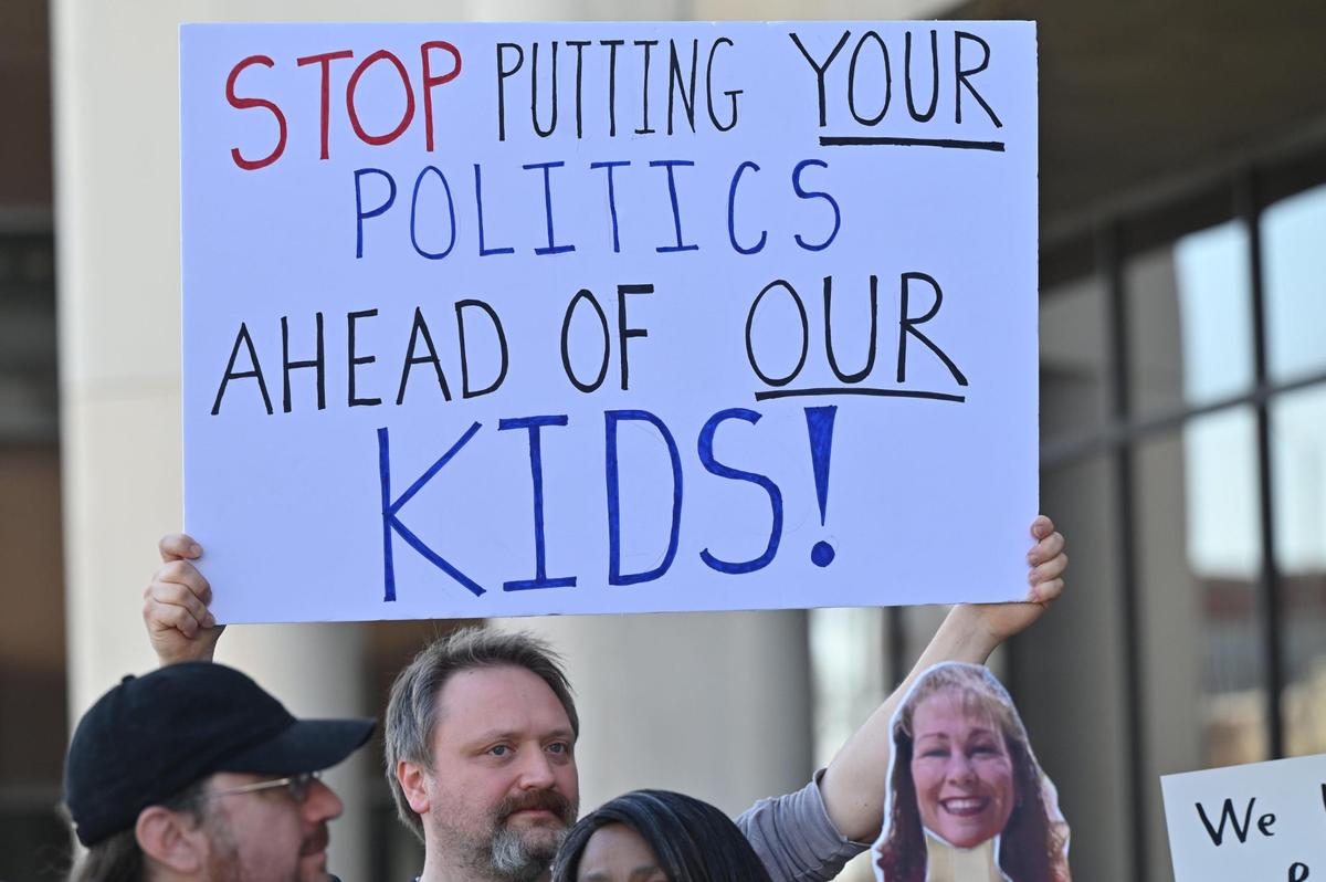 Alexander II Elementary School PTA member Sean Bewick holds a sign while protesting the unexpected termination of the principal and assistant principal at Alexander II Elementary School on Friday, March 7, 2025, in front of the Bibb County Board of Education in downtown Macon, Georgia. A small but vocal group of parents and community members protested on Friday afternoon calling for the Bibb County school district to give answers as to why the Alexander II Elementary Schools principals’ contracts were not extended.