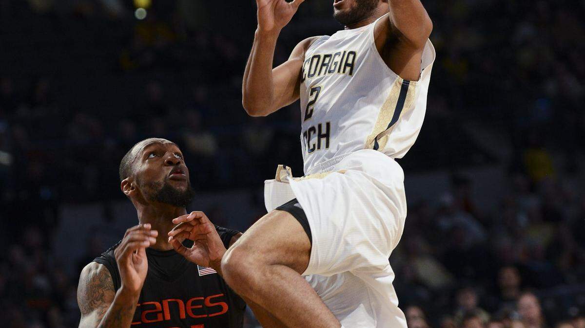Georgia Tech guard Adam Smith, right, shoots over Miami forward Kamari Murphy (21) during the second half of an NCAA college basketball game, Sunday, Feb. 7, 2016, in Atlanta. (AP Photo/Jon Barash)
