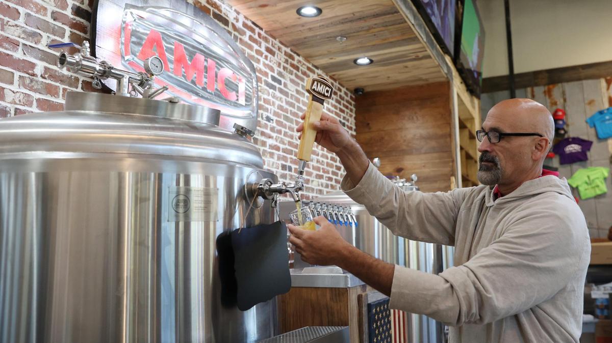 Amici corporate brewmaster Alex O’Kelley pours a glass of “Lazy Daze” West Coast IPA from the Perry location of Amici on Wednesday, Oct. 16, 2024, in Perry, Georgia. “Lazy Daze” is one of the four beers that will be brewed in house at the Amici in Perry.