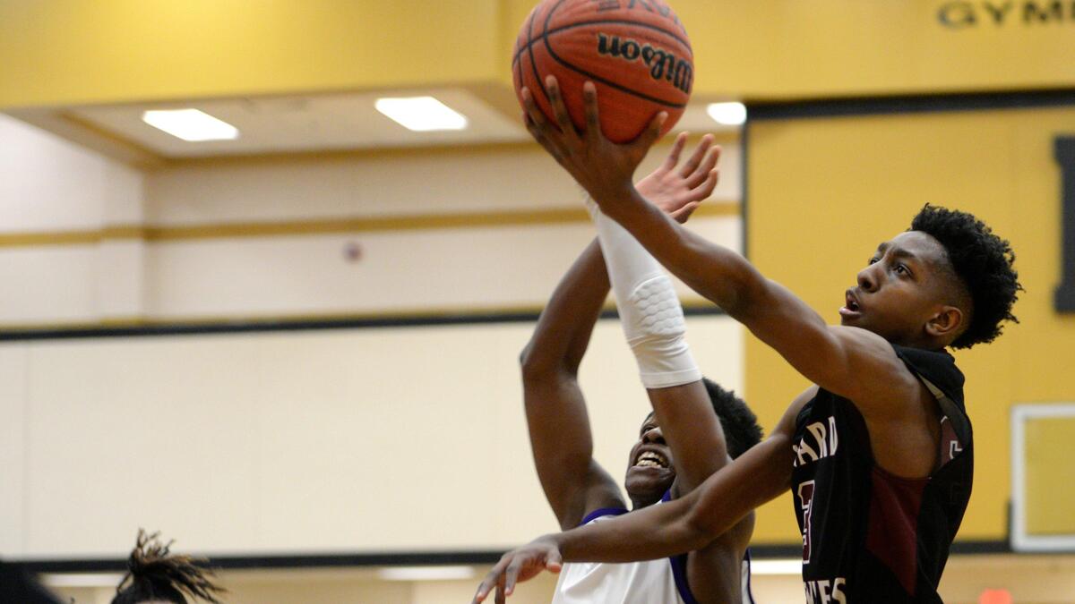 Howard’s Collin Tarver (3), right, shoots with Upson-Lee’s Jarrett Adderton (2) defending in the region 2-AAAA championship on Friday at Mary Persons High School.