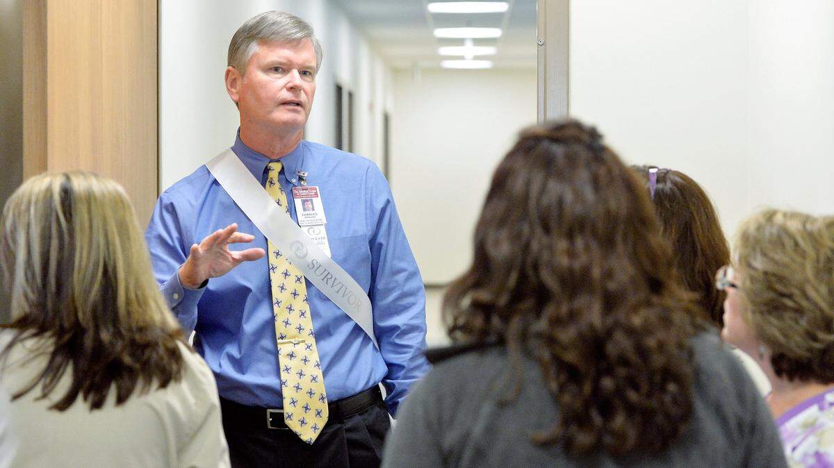 Cancer survivor and health educator Charles Krauss leads a tour of the second floor of the new Peyton Anderson Cancer Center, Navicent Health, at 800 First St. in this 2014 file photo.