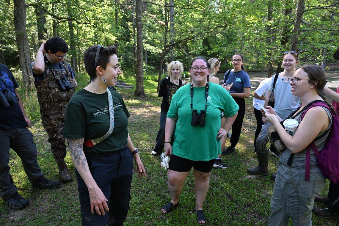 Professor Michelle Moyer (left) speaks with students while checking prothonotary warblers nesting boxes at Andalusia Farm on Friday, April 17, 2026, in Milledgeville, Ga. Moyer led undergraduate students in the field to check the status of the nesting boxes they built and installed earlier in the semester.