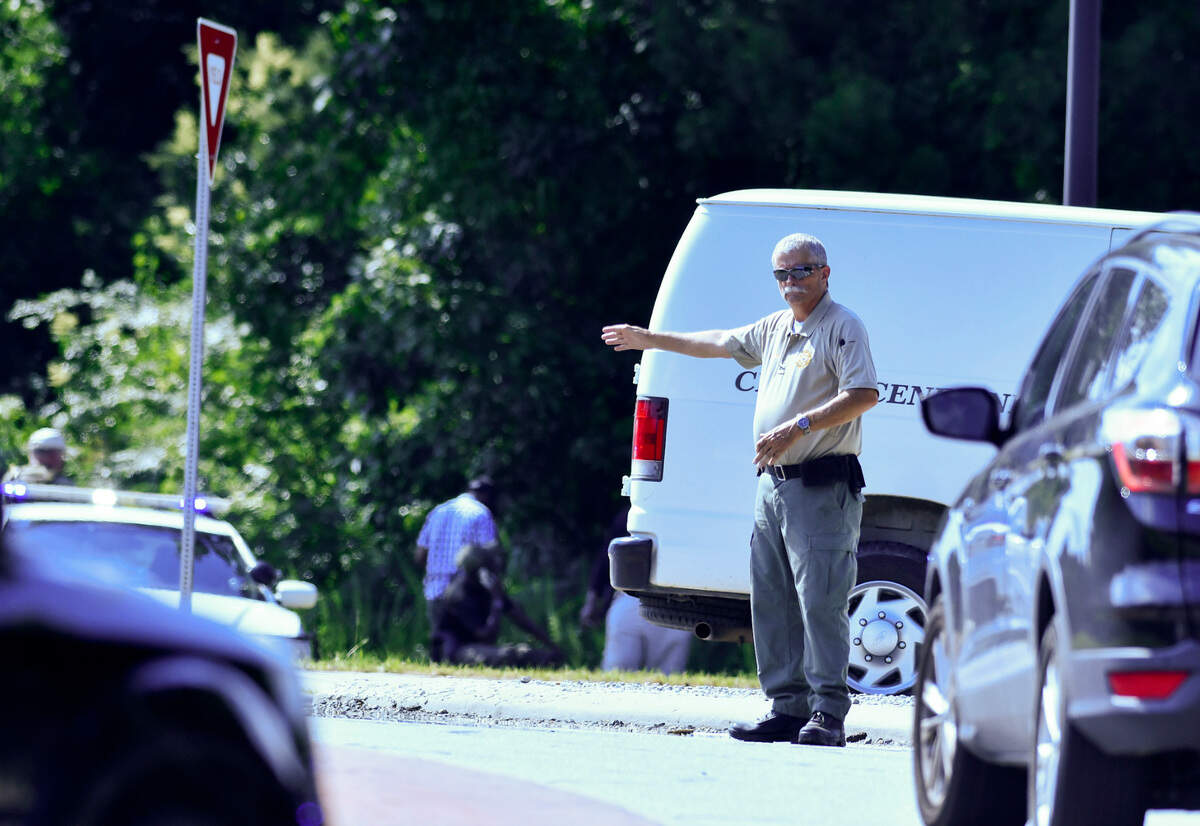Traffic is diverted around a roundabout during a search for suspects who reportedly fired at undercover Bibb County Sheriff’s deputies Monday afternoon in West Bibb County.