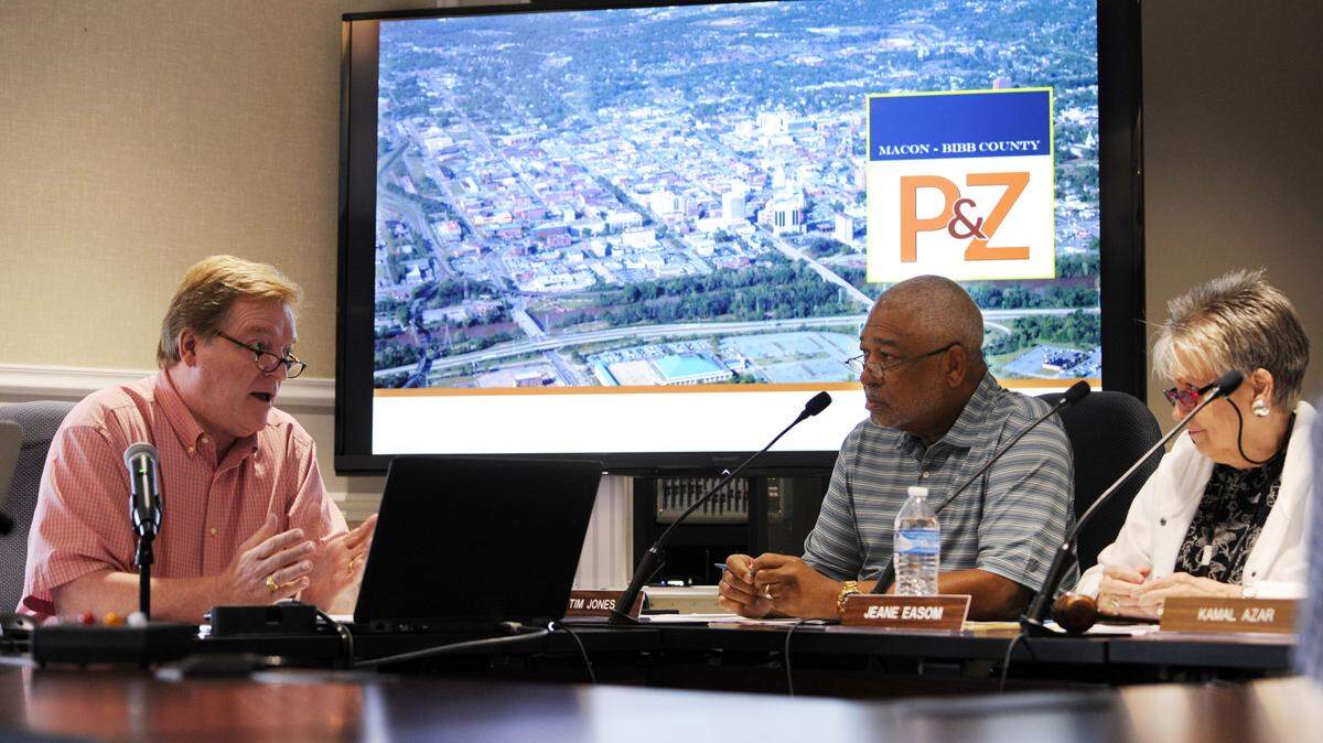Macon-Bibb County Planning & Zoning Commission Executive Director Jim Thomas tells commissioners including Tim Jones, center, and Jeane Easom, right, in July that a proposed fee increase would help offset a lack of county funding. Some Macon-Bibb County commissioners now want to bring planning and zoning under their control.
