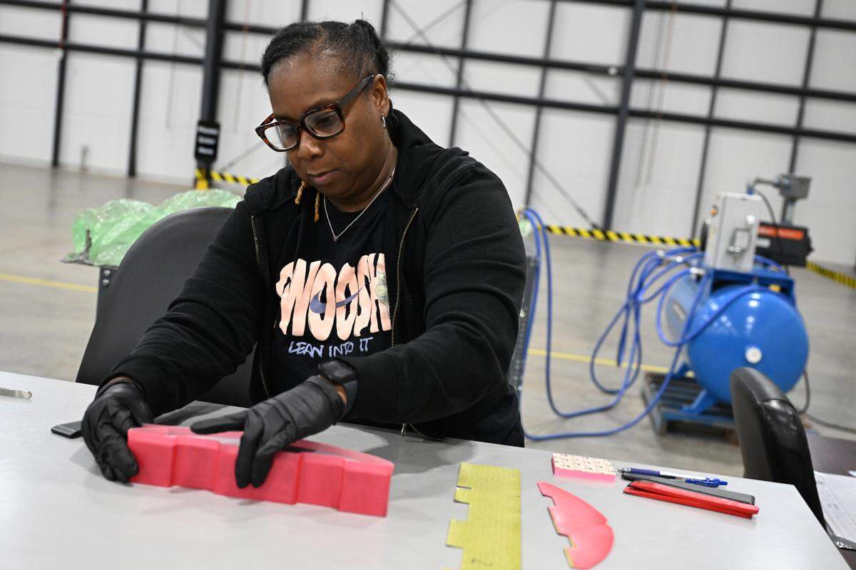 KIHOMAC senior composite technician Demetrius Atkins works on a composite piece on Wednesday, March 25, 2026, at the plant in Warner Robins, GA. The piece will be sent off to another KIHOMAC plant in Utah for completion.