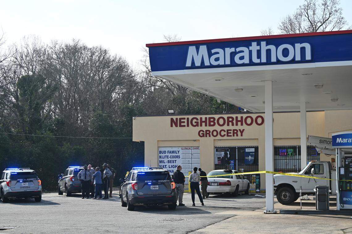 Bibb County Sheriff’s Office deputies surround Neighborhood Grocery on Napier Avenue on Thursday, Jan. 8, 2026, in Macon, Georgia. A 33-year-old woman has died after an aggravated assault incident and authorities believe the woman was driven to the store after being shot. 