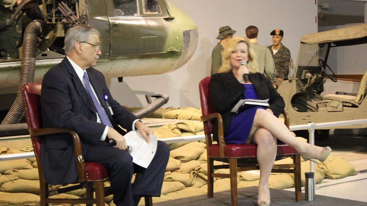WAYNE CRENSHAW/THE TELEGRAPH 
 April Bragg, president of the Robins Regional Chamber of Commerce, introduces Houston Healthcare CEO Cary Martin at Thursday's Eggs and Issues Breakfast at the Museum of Aviation.
