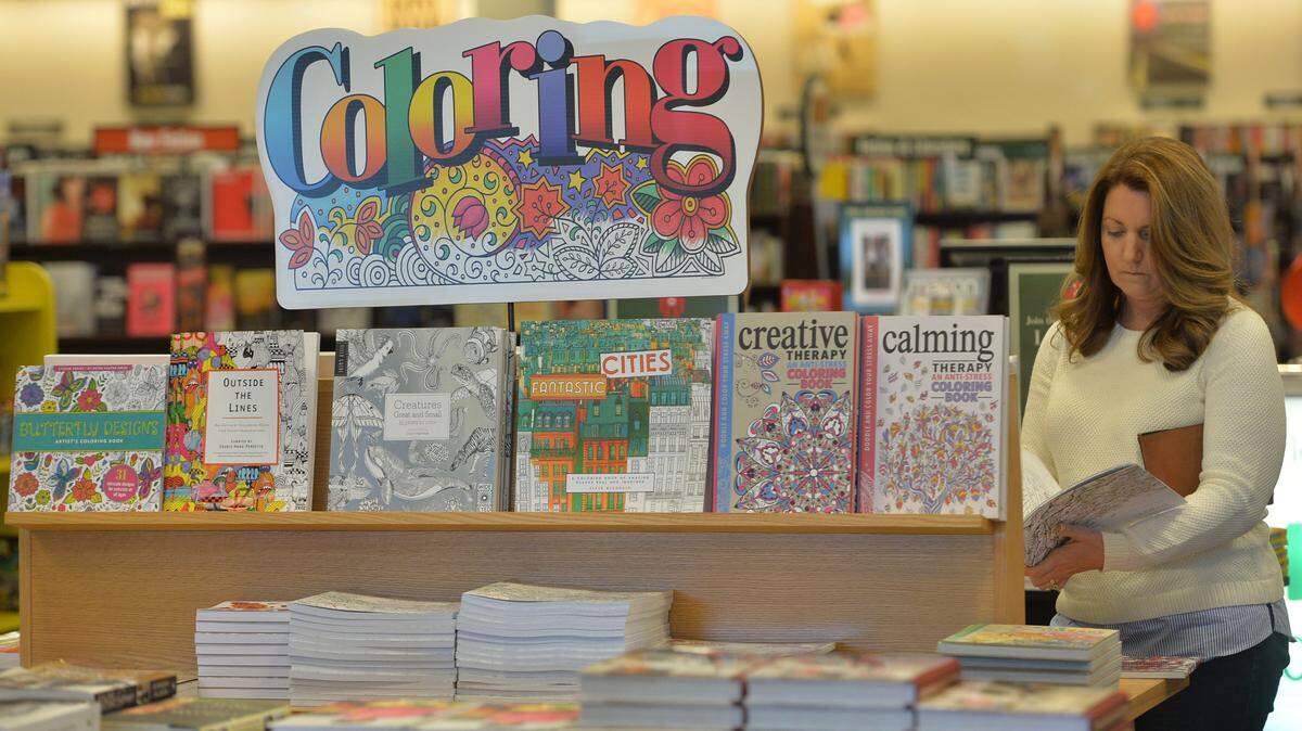 BEAU CABELL/THE TELEGRAPHKristie Lanier, of Bonaire, looks at coloring books for adults at Barnes & Noble in Macon, where store managers say they're having a difficult time keeping up with the demand. Lanier said she was buying them for her two children -- ages 20 and 16 -- who are studying for final exams. "They're kind of a de-stresser," she said of the therapeutic effects.
