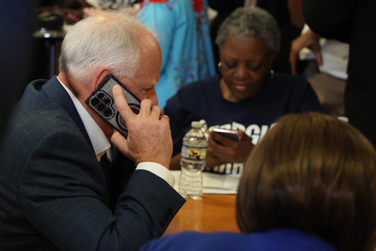 Minnesota governor and Democratic vice presidential candidate Tim Walz speaks to a voter while phone banking at the Macon Bibb County Democratic Committee office on Tuesday, Sept. 17, 2024, in Macon, Georgia. Walz visited the office on National Voter Registration Day and spoke on the phone with potential Middle Georgia voters as a part of his Macon campaign stop.