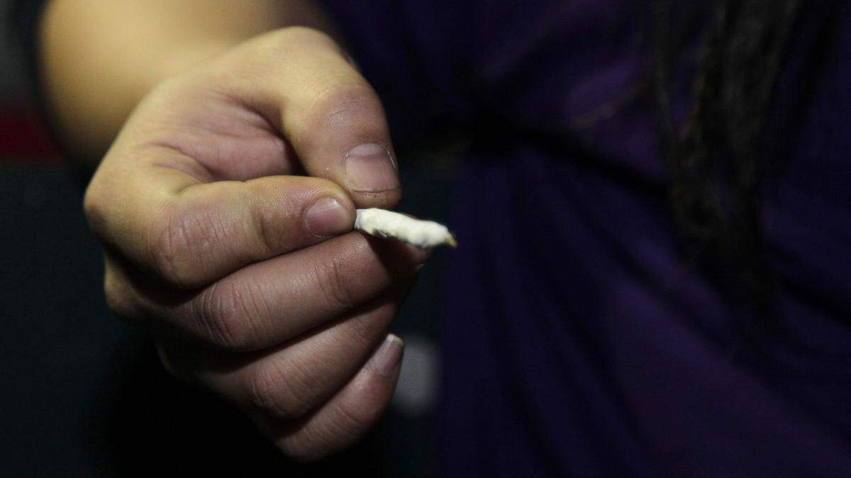 TED S. WARREN/ASSOCIATED PRESS 
 A person holds a freshly rolled marijuana joint. Seven bills filed in the Georgia Legislature that would loosen some cannabis laws.