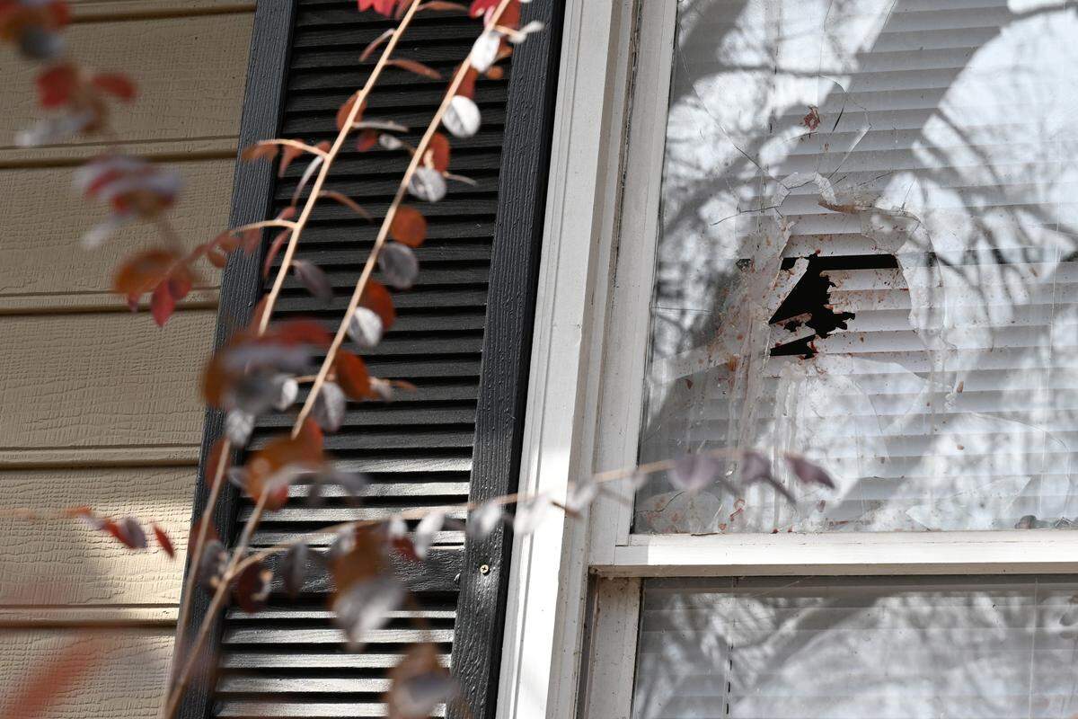A shattered window with blood sits in front of a home on Ridgeview Circle in the Lake Wildwood neighborhood on Wednesday, Feb. 18, 2026, in Macon, Georgia. A man allegedly killed his wife, daughter and pets, then died by suicide in their home after officers came to issue an eviction notice on Tuesday, Feb. 17, according to the Bibb County Sheriff’s Office.