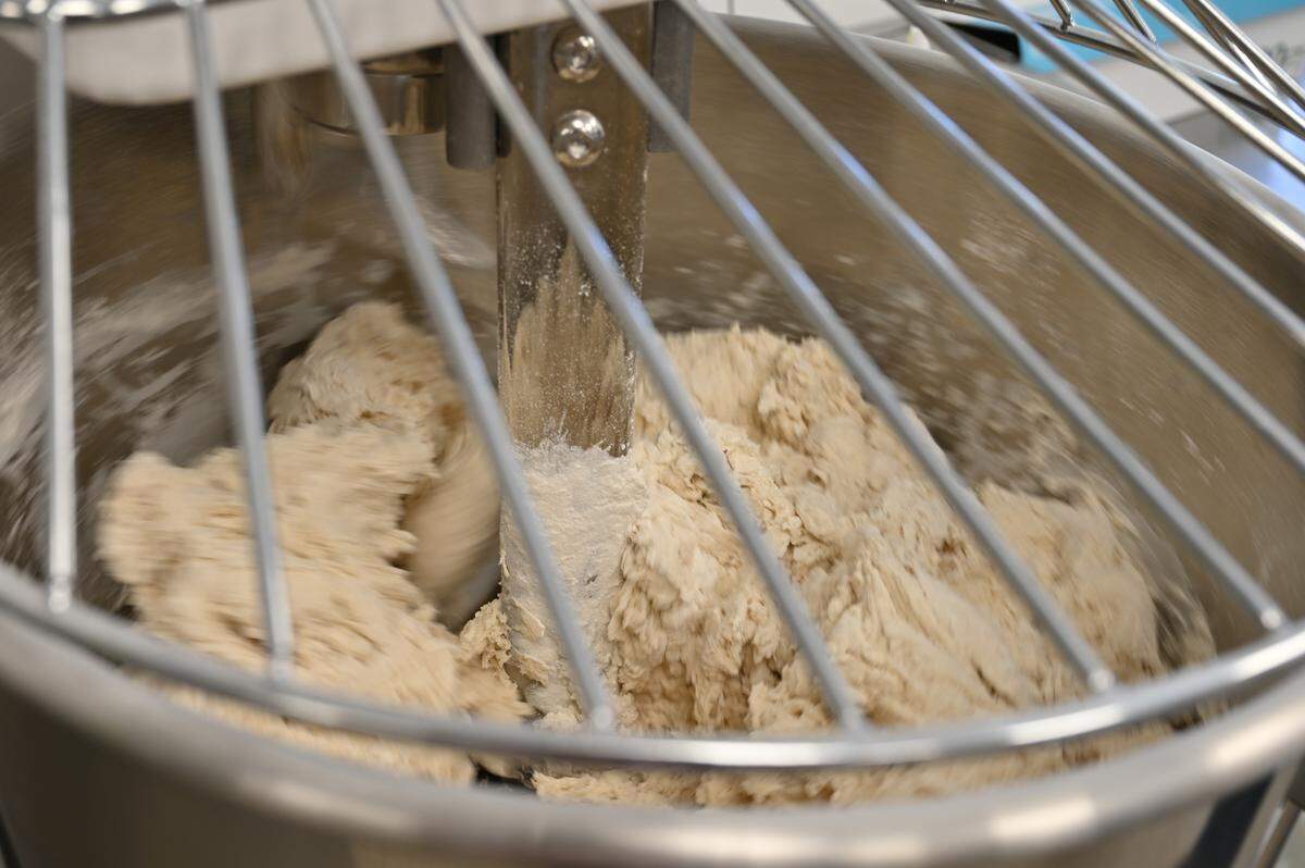 Pizza dough stirs inside of a mixer inside of the new Holy Pie! Pizzeria in Perry, Georgia.