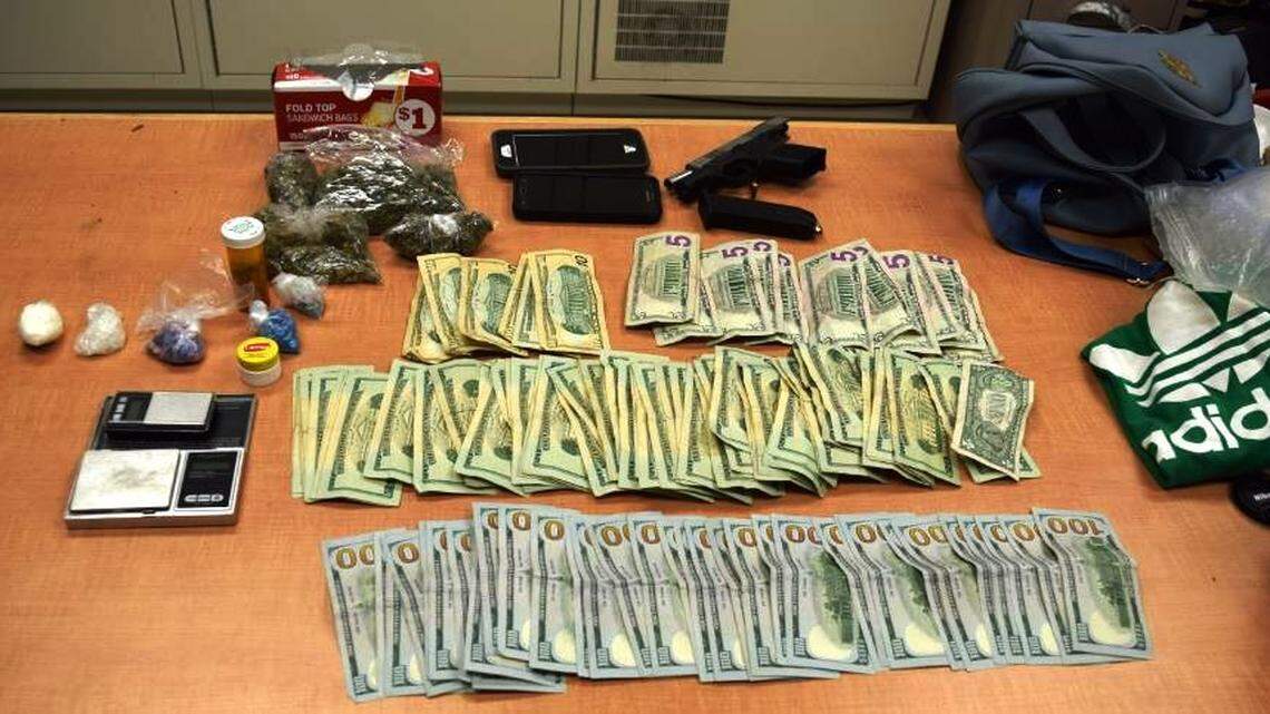 Centerville police seized more than $4,500 cash, a stolen gun, digital scales and suspected drugs including marijuana, cocaine, methamphetamine and ecstasy displayed early Friday after in traffic stop led to the arrest of a Warner Robins man.