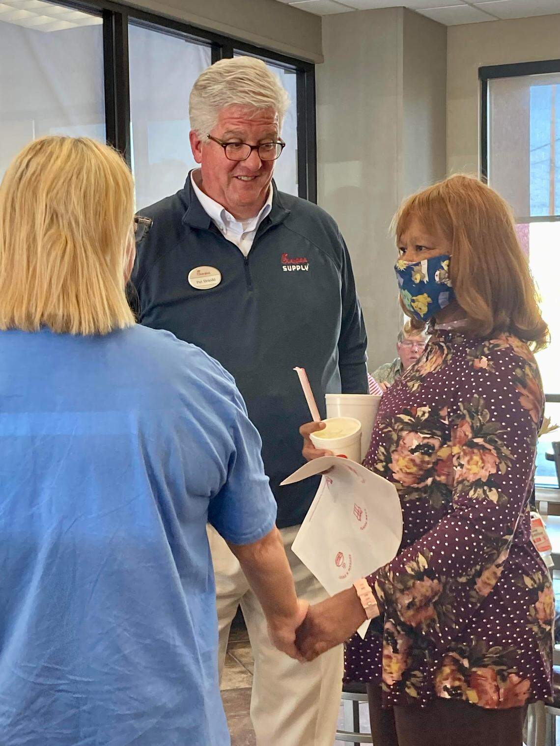 Chick-fil-A owner and operator Pat Braski talks with an employee and a customer during the “last bite” event at the restaurant at 1867 Watson Blvd. the day before it closed Friday. The restaurant’s new location at 621 Russell Parkway opens Thursday.
