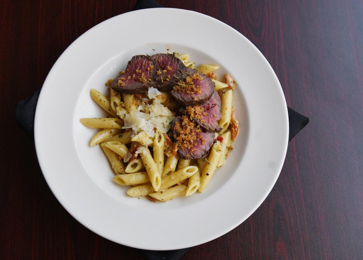 A pasta dish with a pesto cream sauce, sun-dried tomatoes and filet medallions sits on a table at Zavala at Barrington on Monday, June 17, 2024, in Macon, Georgia. Zavala began as a local catering business and moved to its Barrington Hall location in February, where renovations are ongoing in the club.