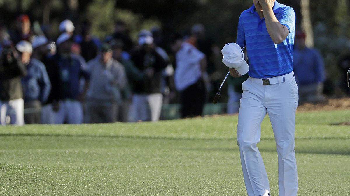 Jordan Spieth walks on the 18th fairway with his caddie Michael Greller during the final round of the Masters golf tournament Sunday in Augusta.