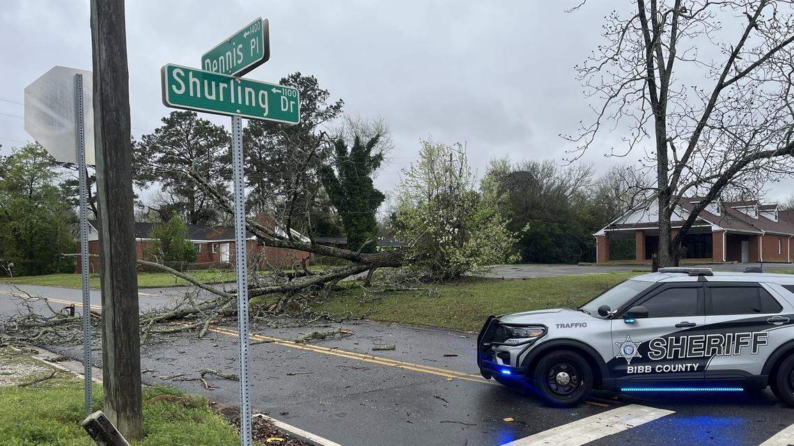 A tree fell across Dennis Place off Shurling Drive after a storm triggered tornado warnings on the morning of Thursday, March 12, 2026, in east Macon, Ga. A Bibb County Sheriff’s Office vehicle blocked the road from traffic.