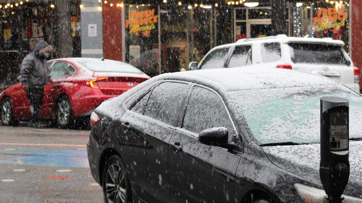 Snow covers cars in downtown Macon on Sunday, Jan. 18, 2026.