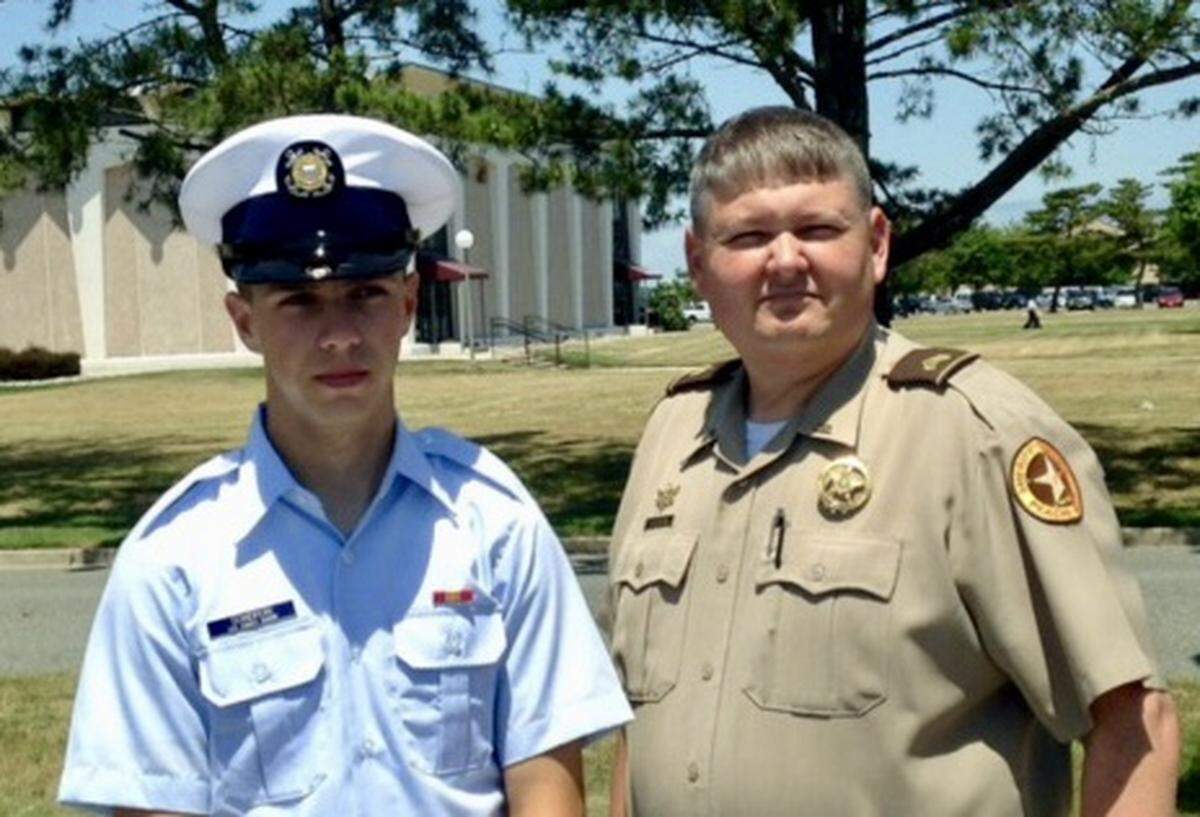 Jacob Sondron, left, with his father Patrick Sondron, at Jacob’s graduation from Coast Guard boot camp in 2014.