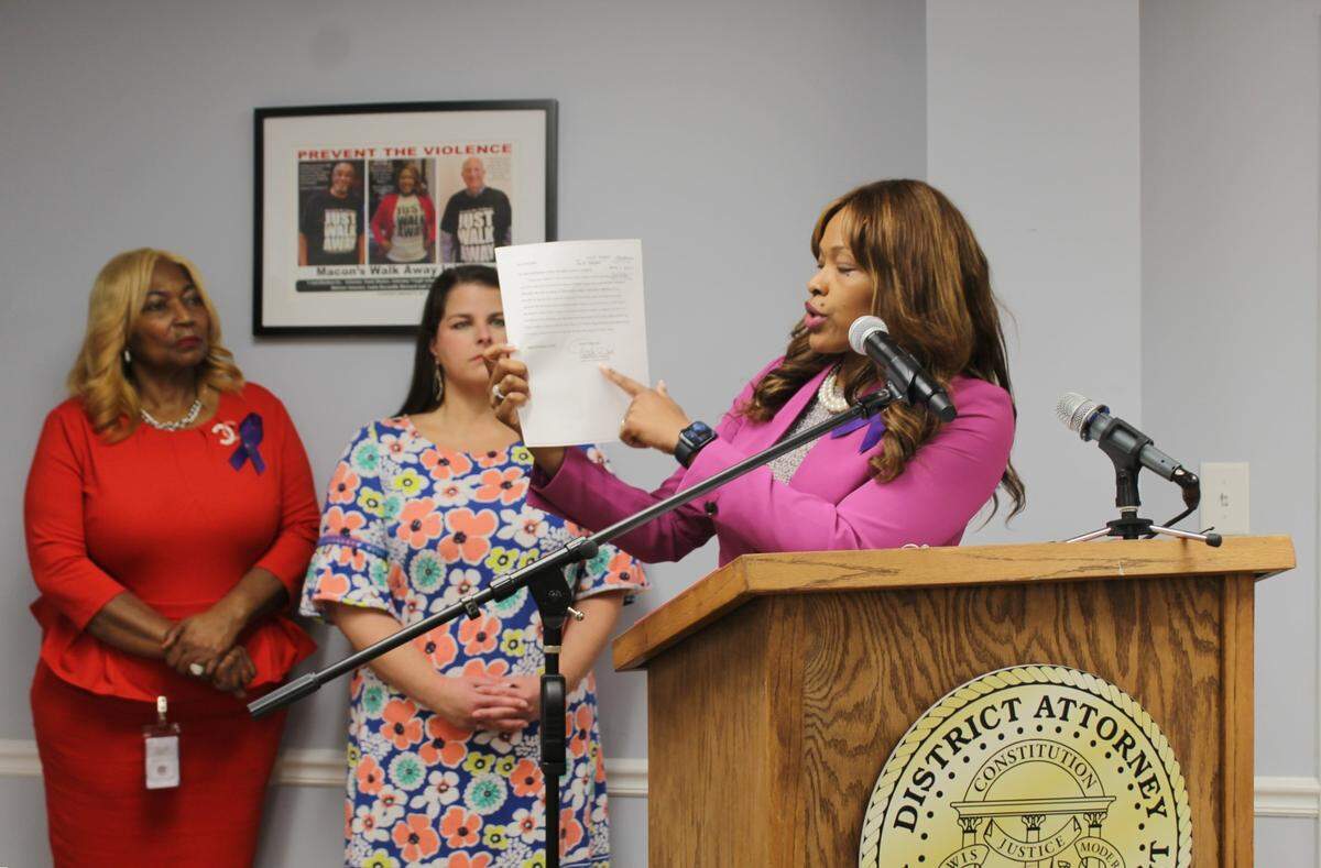 District Attorney Anita Howard points to a petition filed by Cotina Fuller on April 18, 2024 for a family violence protective order against her husband Wayne Fuller, during a press conference August 19. Wayne killed his wife and died by suicide August 16.