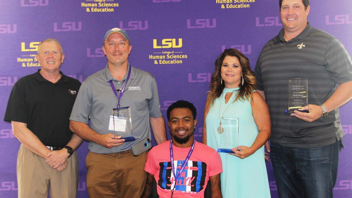 Devon Gales poses for photo July 9, 2018, with attendees at the Emergency Preparation for Athletics Course, hosted by LSU.