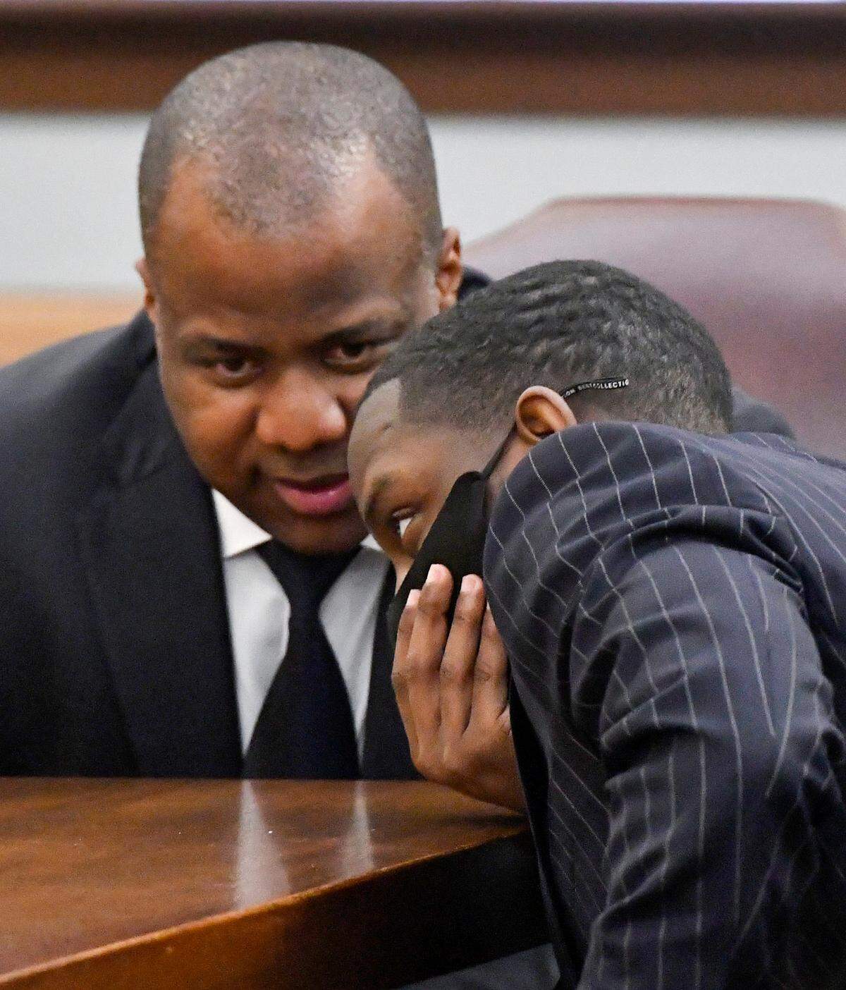 Demarcus Little has a conversation with his lawyer Benjamin Davis in a Peach County courtroom Tuesday, the opening day of his murder trial in the February 2020 death of his girlfriend, Fort Valley State University student Anitra Gunn.