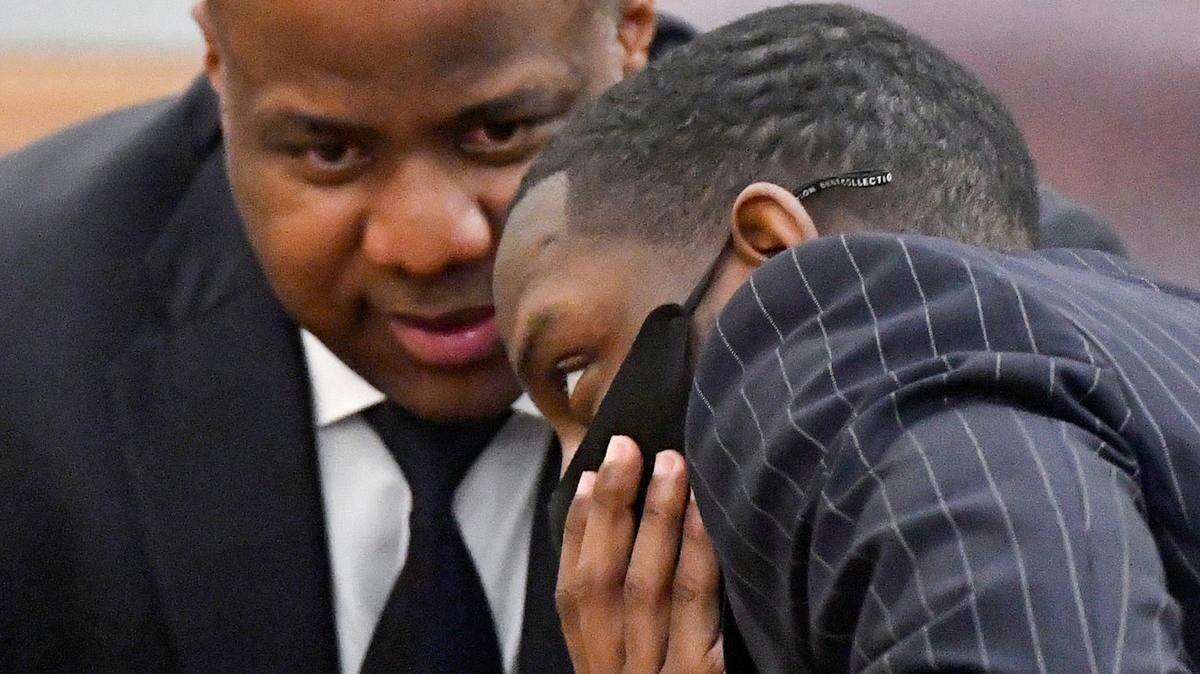 Demarcus Little has a conversation with his lawyer Benjamin Davis in a Peach County courtroom Tuesday, the opening day of his murder trial in the February 2020 death of his girlfriend, Fort Valley State University student Anitra Gunn.