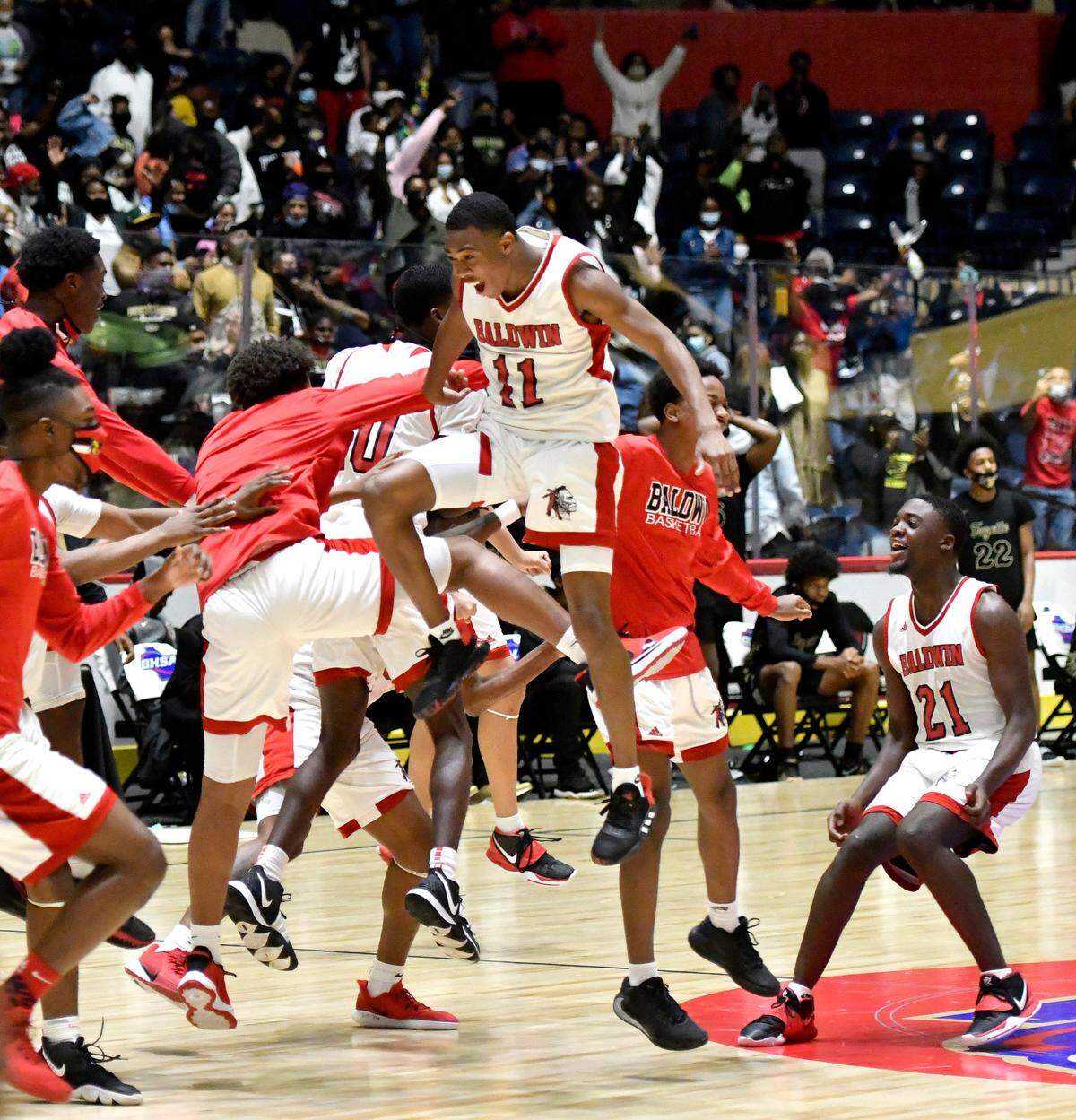 Baldwin players celebrate their 54-53 last second over Fayette County during the GHSA 4A State Championship game Wednesday night in Macon.